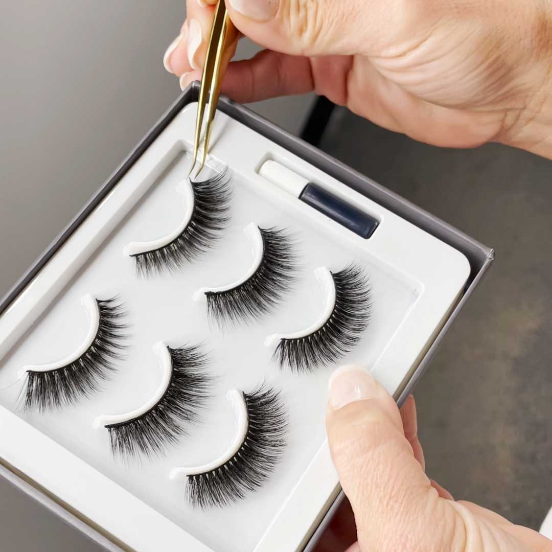 The Threesome | 3 Way Strip Lash Set displayed in packaging, showcasing dramatic styles of reusable fake eyelashes with tweezers.