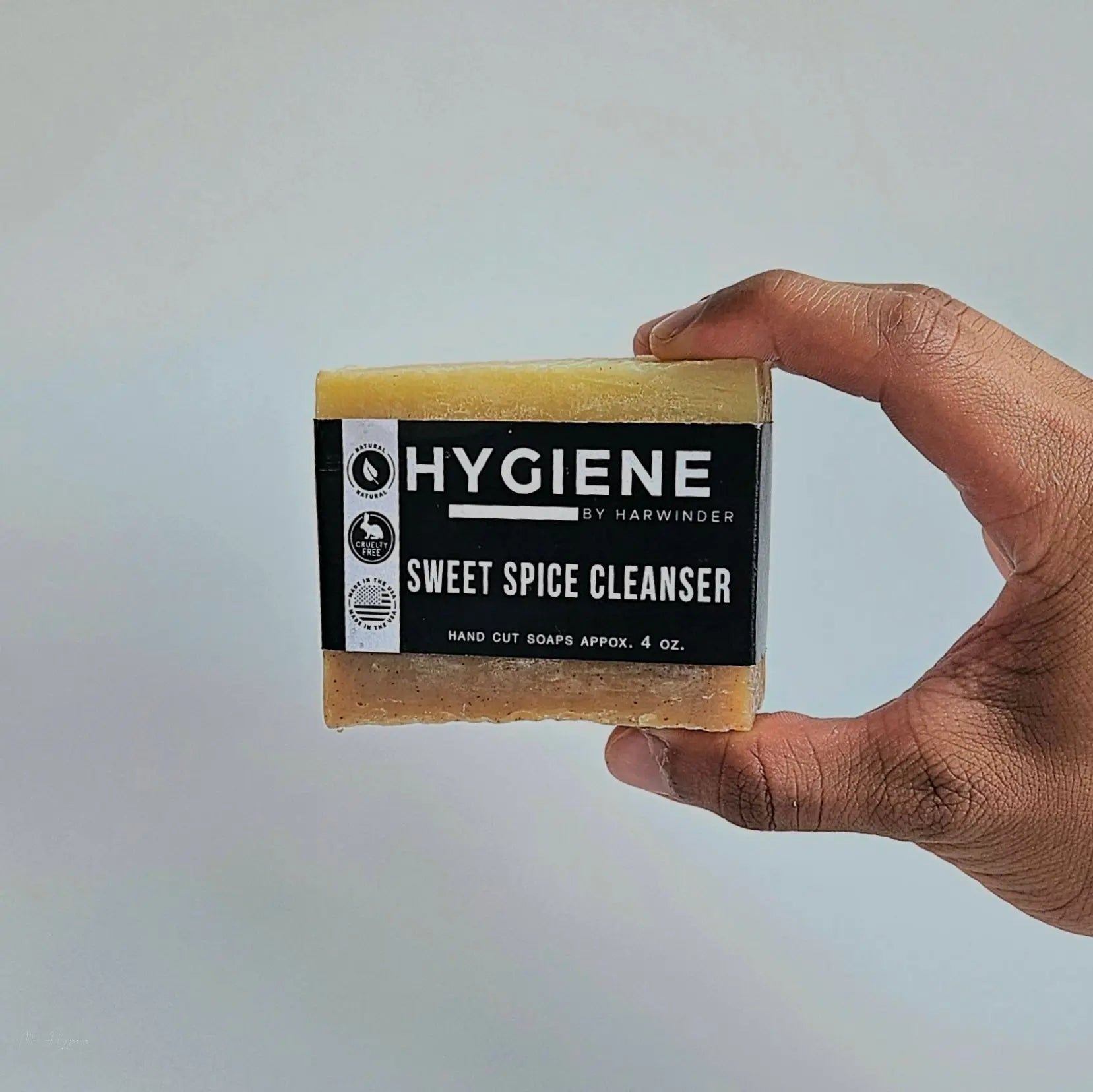 Hand holding Sweet Spice Cleanser Luxury Mens Soap against a plain background.