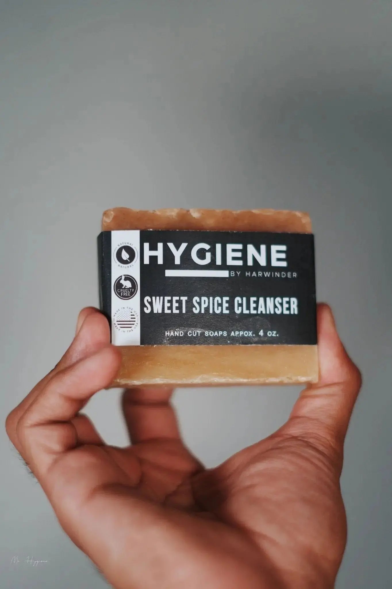 Hand holding Sweet Spice Cleanser Luxury Mens Soap with eco-friendly packaging