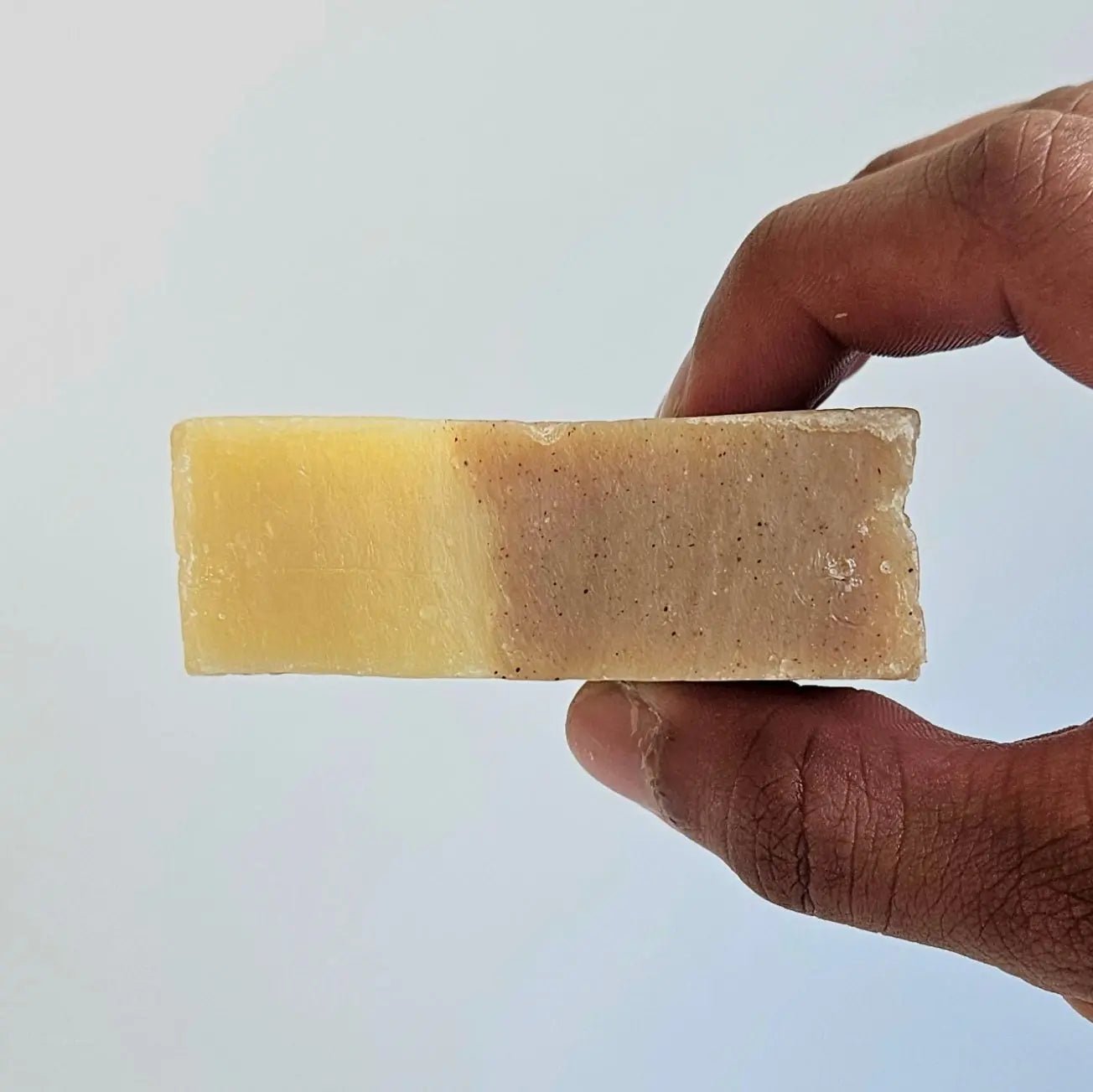Hand holding Sweet Spice Cleanser Luxury Mens Soap with dual tones