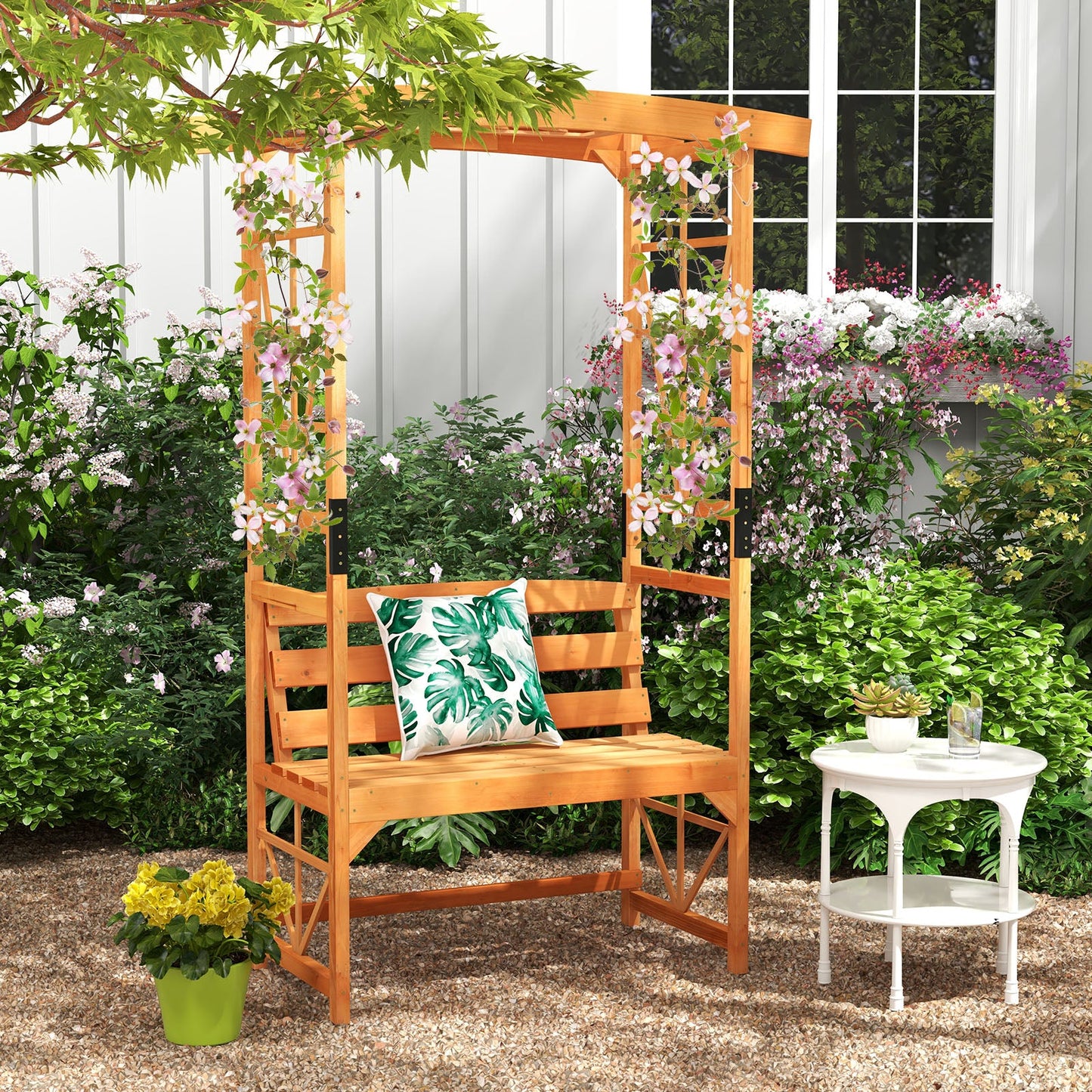 6.2 Feet Tall Patio Garden Arbor with Pergola and 2-Seat Bench for Garden Lawn Backyard Decoration-Yellow in lush garden setting