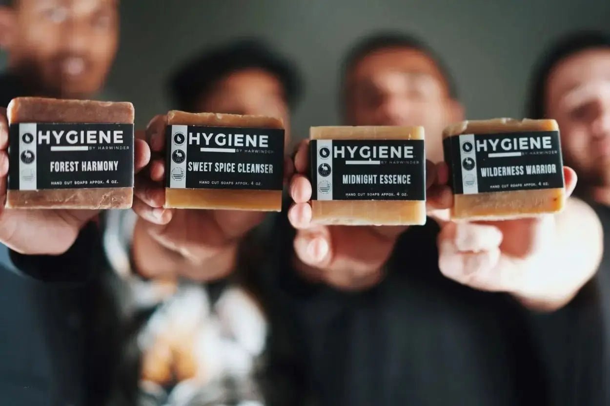 Men holding Premium Natural Bar Soap Collection for Men featuring Forest Harmony, Sweet Spice Cleanser, Midnight Essence, Wilderness Warrior.