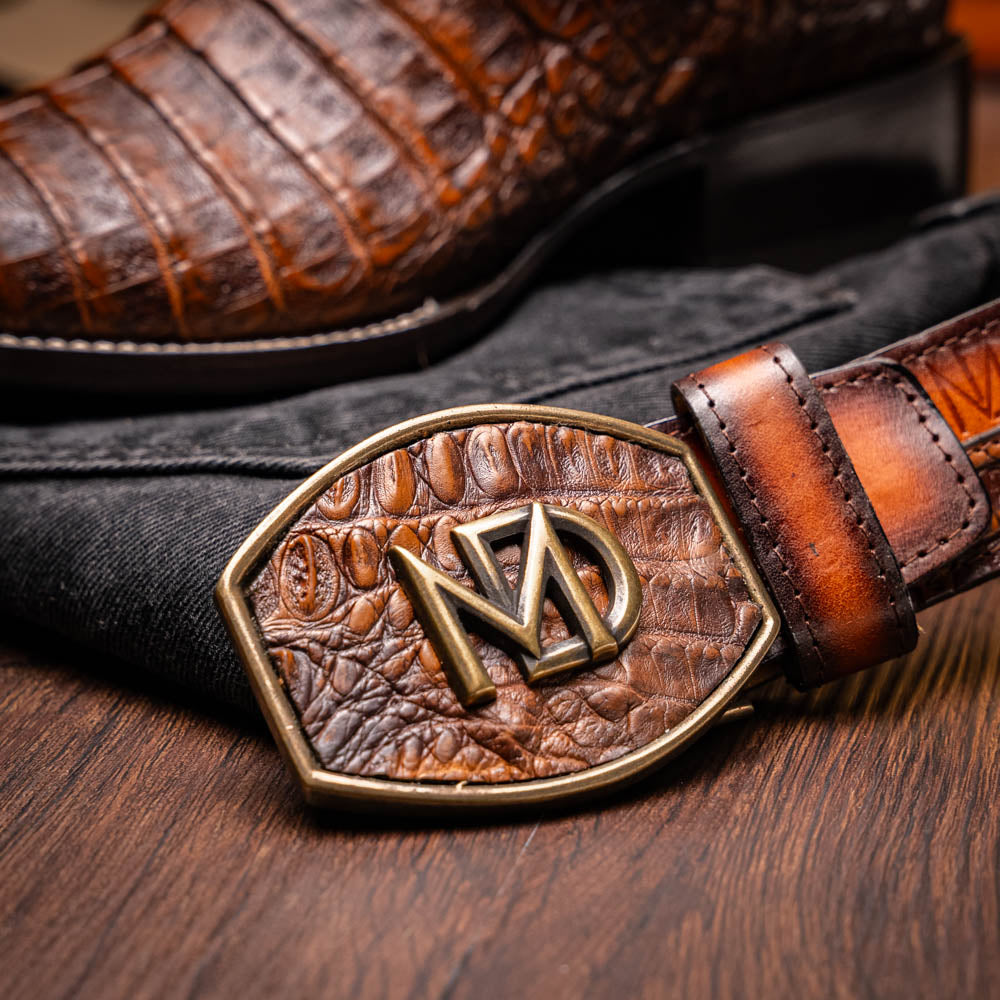 Tucson Aged Maple belt showcasing genuine caiman belly texture and elegant design, paired with cowboy boot from the Western Collection