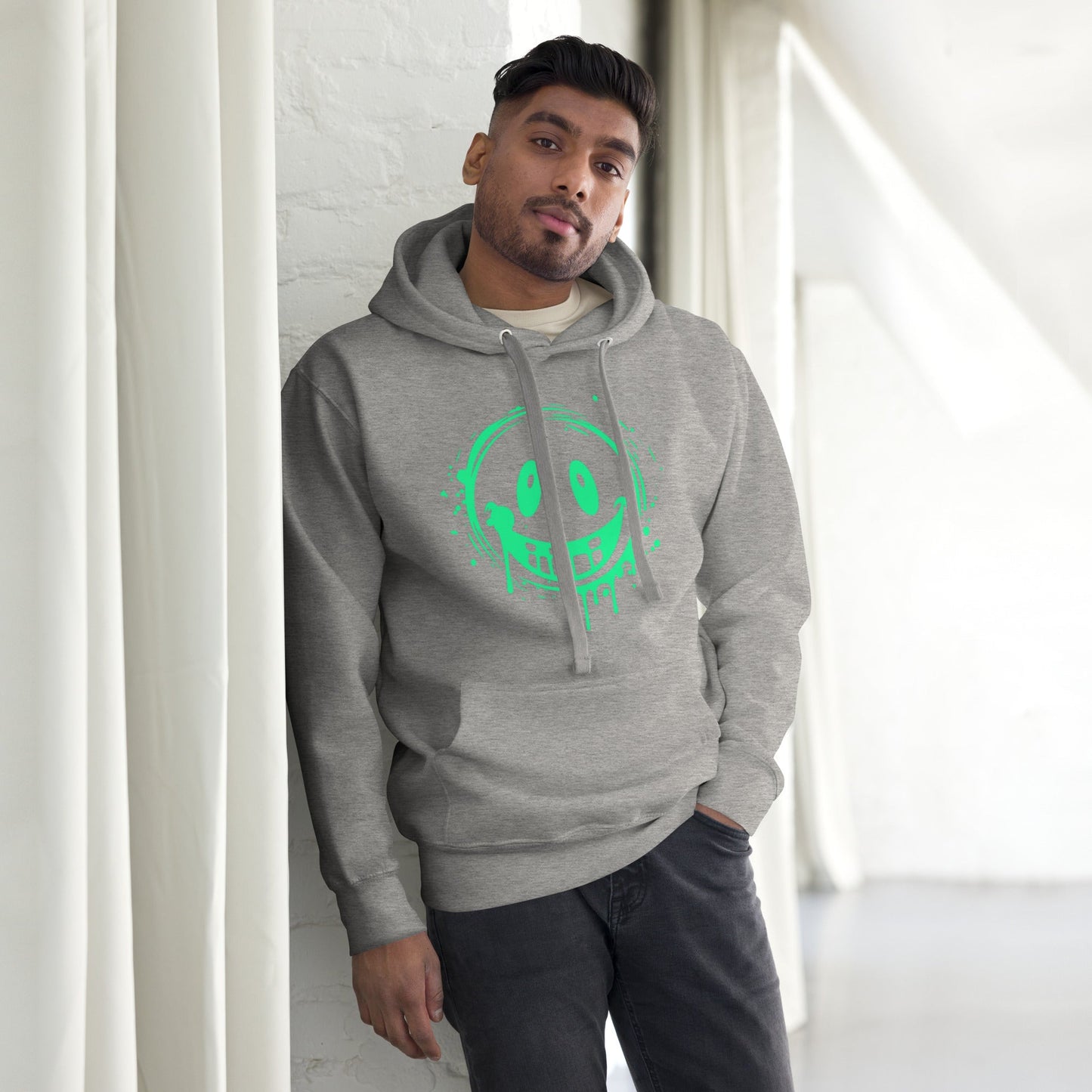 Men’s Green Smile Hoodie – Trendy & Comfortable Streetwear with a Fun Twist worn by a model leaning against a wall