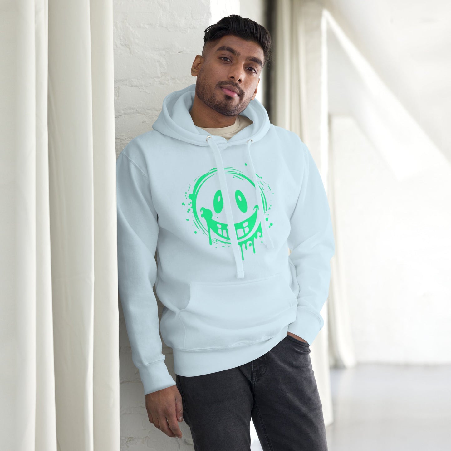 Men’s Green Smile Hoodie – Trendy & Comfortable Streetwear with a Fun Twist modeled by a man in a bright room.