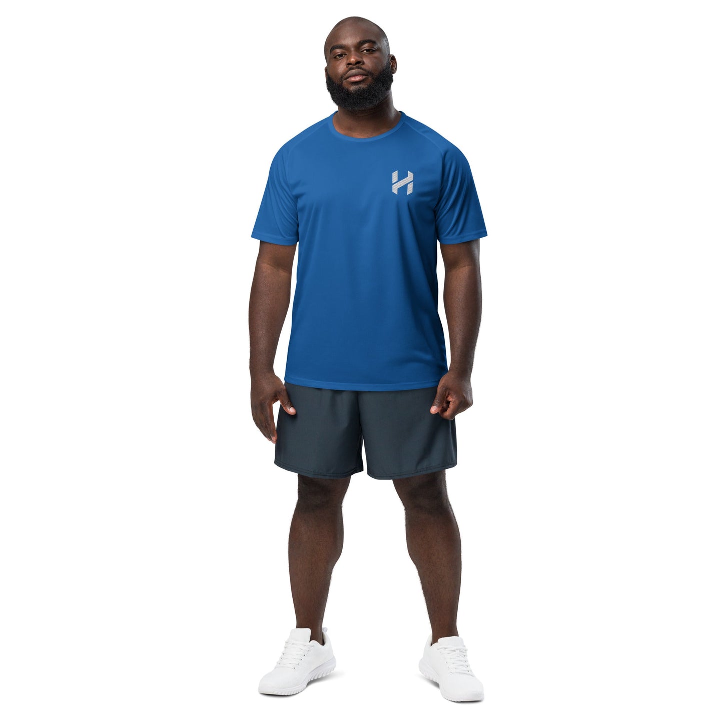 Man wearing blue athletic shirt and black shorts, standing against a white background. Ideal for workouts and sports activities.