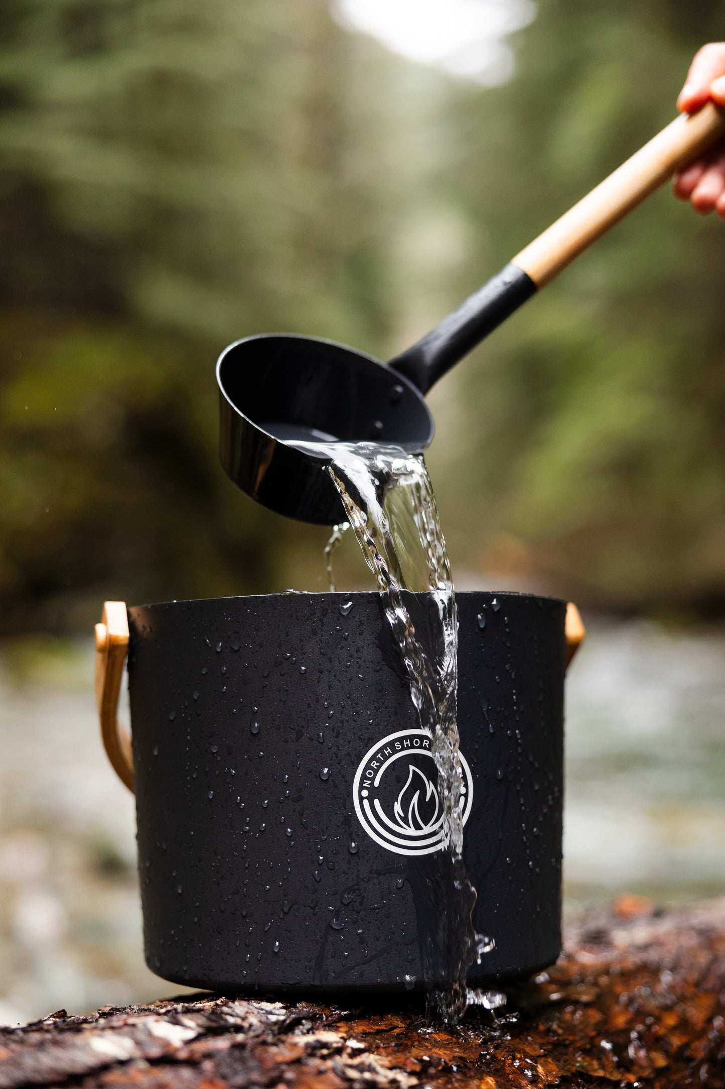 5L Black Aluminum Sauna Bucket and Ladle Set with Elegant Bamboo Handles in a natural setting