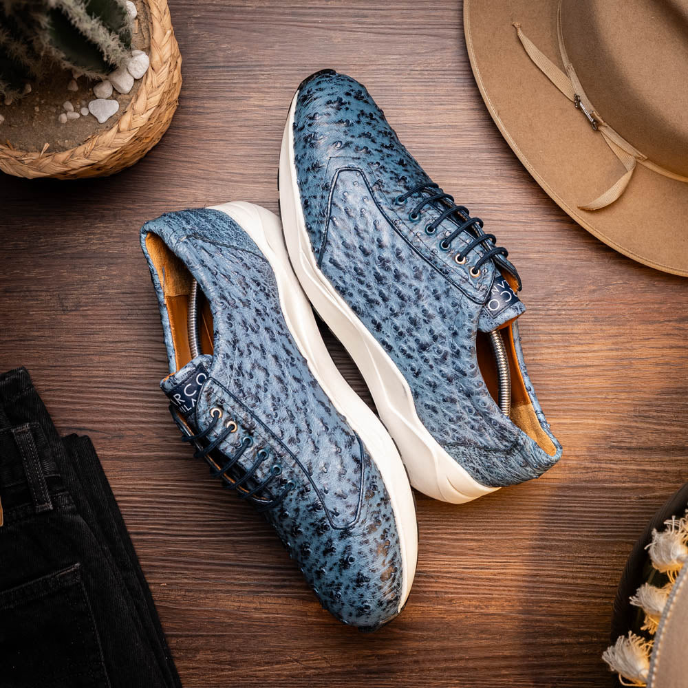Varenna Blue Jeans luxury sneaker made from genuine ostrich skin, showcasing sleek design and sophisticated craftsmanship on a wooden floor.