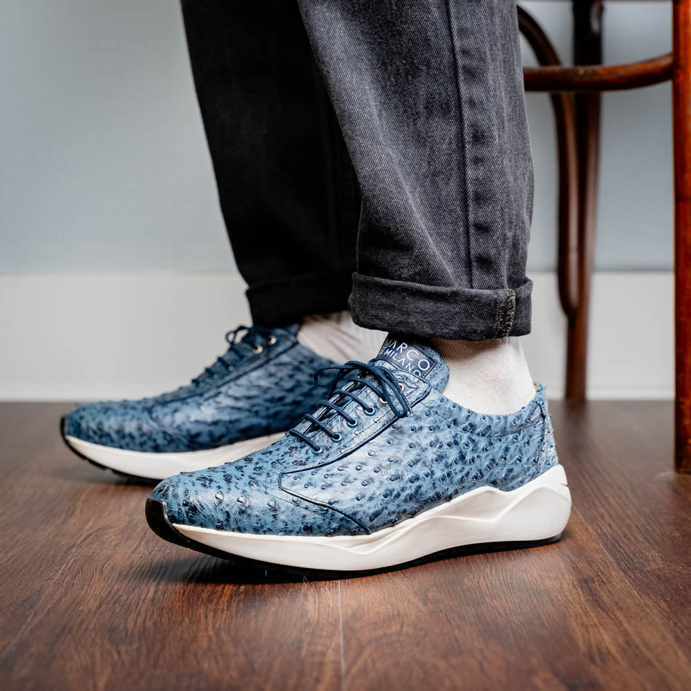 Varenna Blue Jeans luxury sneaker with genuine ostrich skin texture, showcasing sleek design and elegance on a wooden floor.