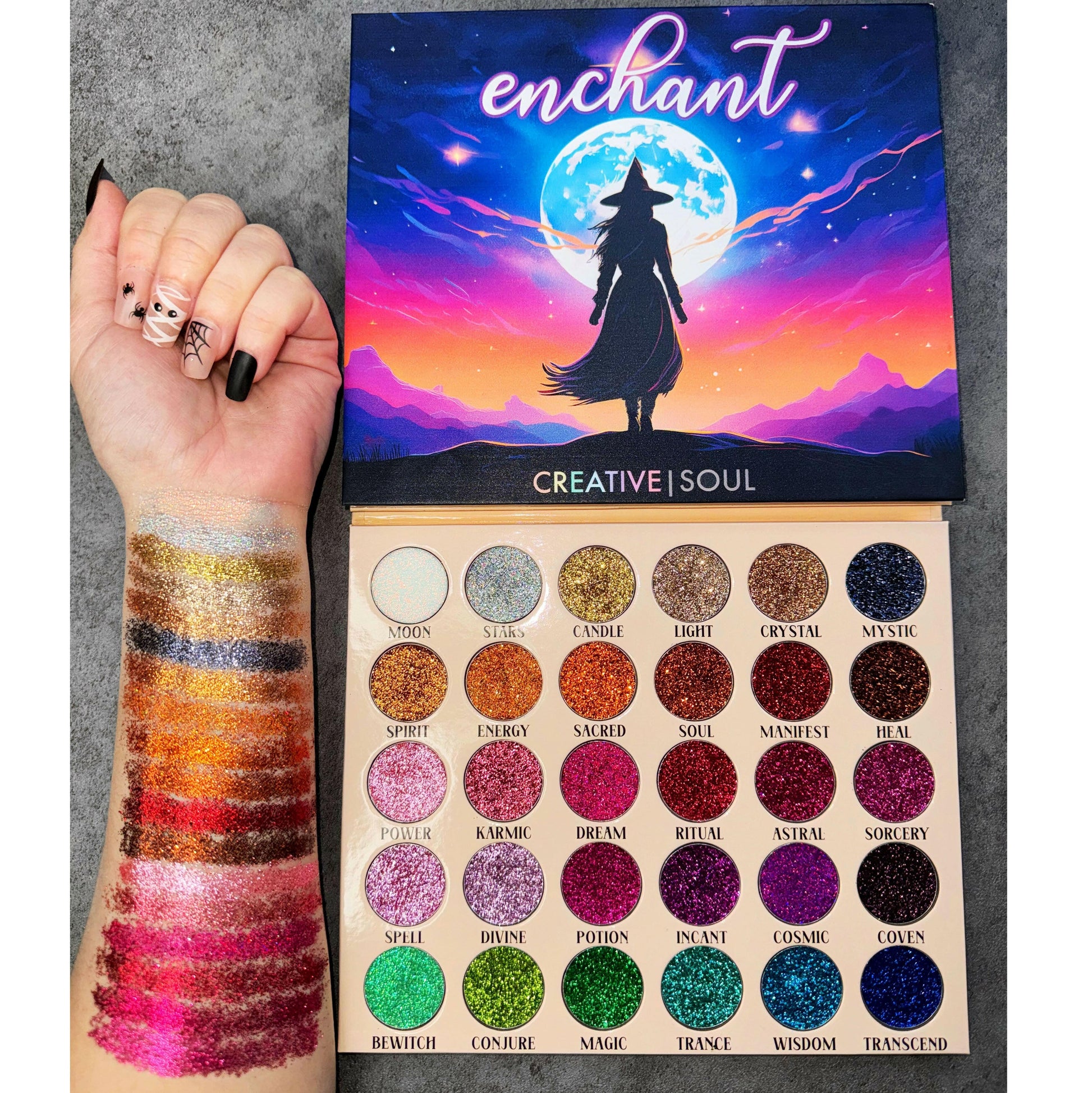Enchant Pressed Glitter Eyeshadow Palette with 30 vibrant glitter shades swatched on arm.