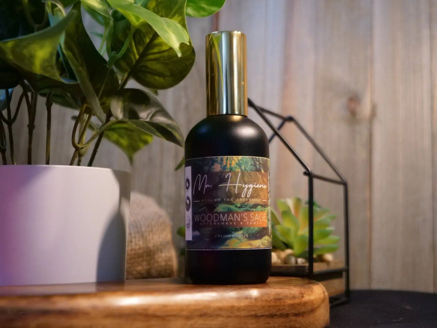 Woodman's Sage Mens Aftershave & Toner bottle on wooden table with plants